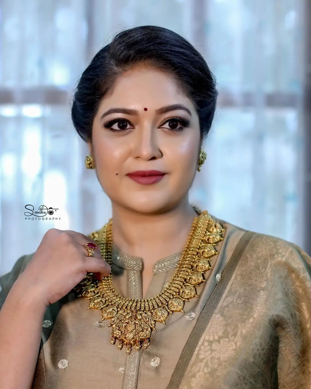 MEGHANA RAJ STILLS IN BEAUTIFUL EARRING JEWELLERY GREEN GOWN